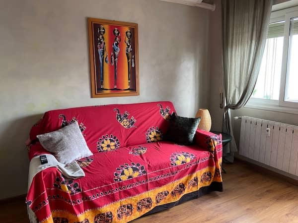 Living area with sofa and dining table in Rome vacation apartment